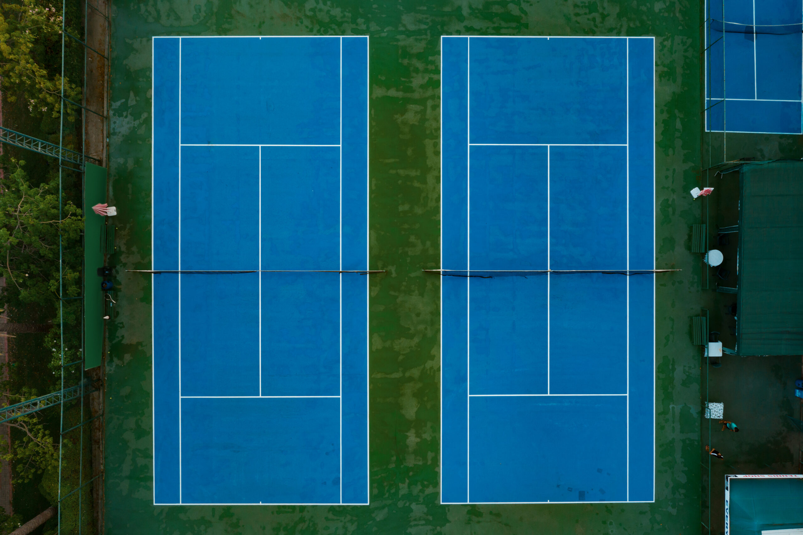 Top view tenis court. Blue lawn with white lines pattern background.